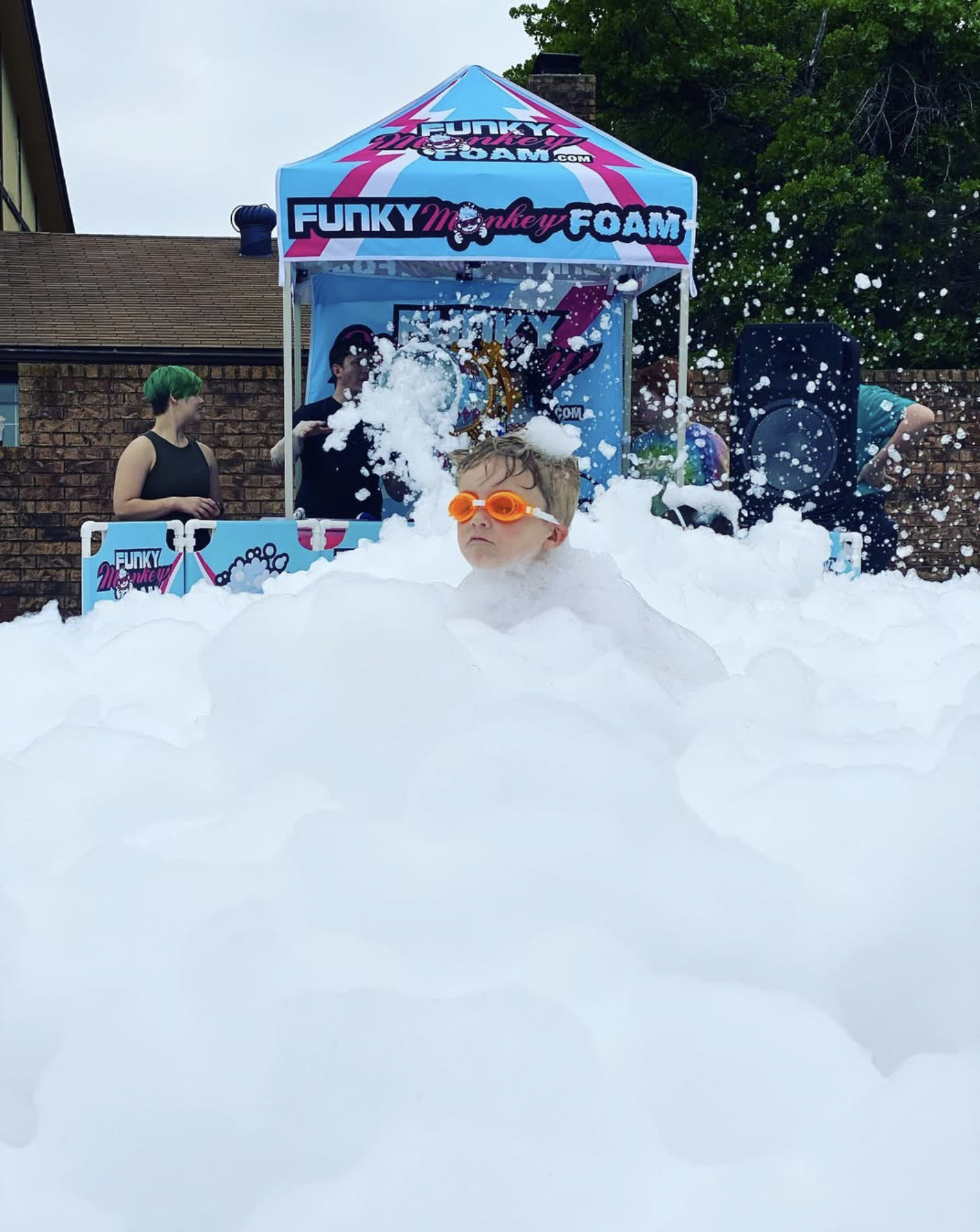 Outdoor foam party at Oklahoma library — kids playing in foam during summer reading program